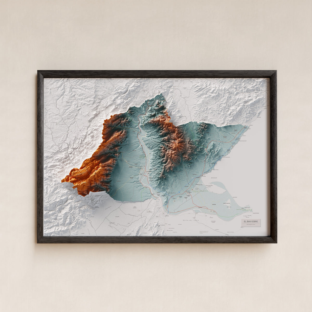 Mapa de relieve del Baix Ebre, con el territorio en color y el entorno en blanco. Presentación con marco. 70 × 100 cm. Estilo Azul y naranja.