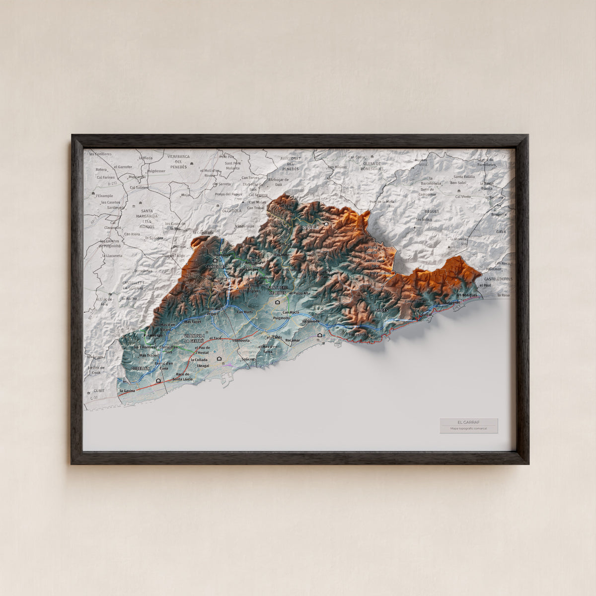 Mapa de relleu del Garraf, amb el territori en color i l’entorn en blanc. Presentació amb marc. 21 × 30 cm. Estil Blau i taronja.