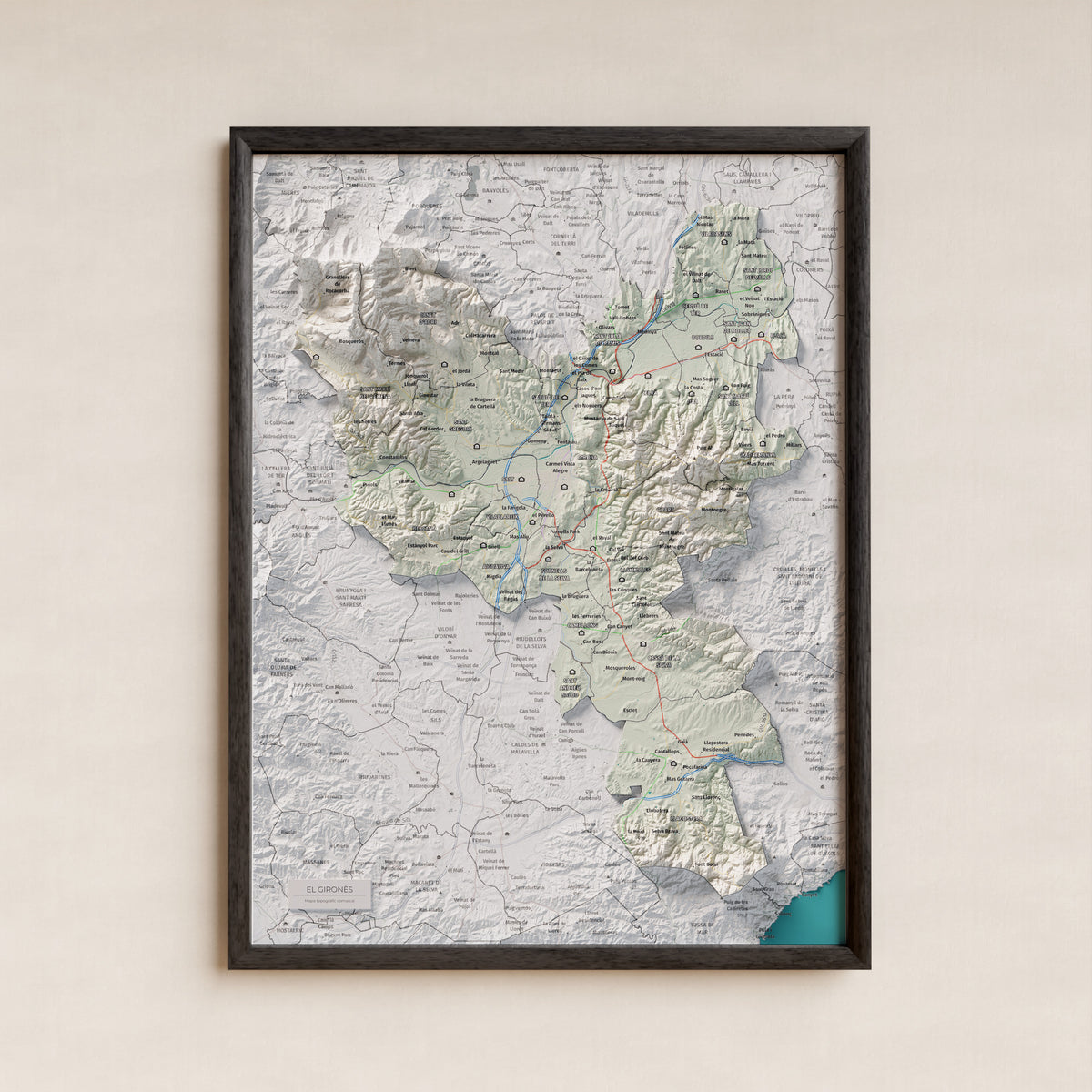 Mapa de relleu del Gironès, amb el territori en color i l’entorn en blanc. Presentació amb marc. 30 × 40 cm. Estil Cartogràfic.