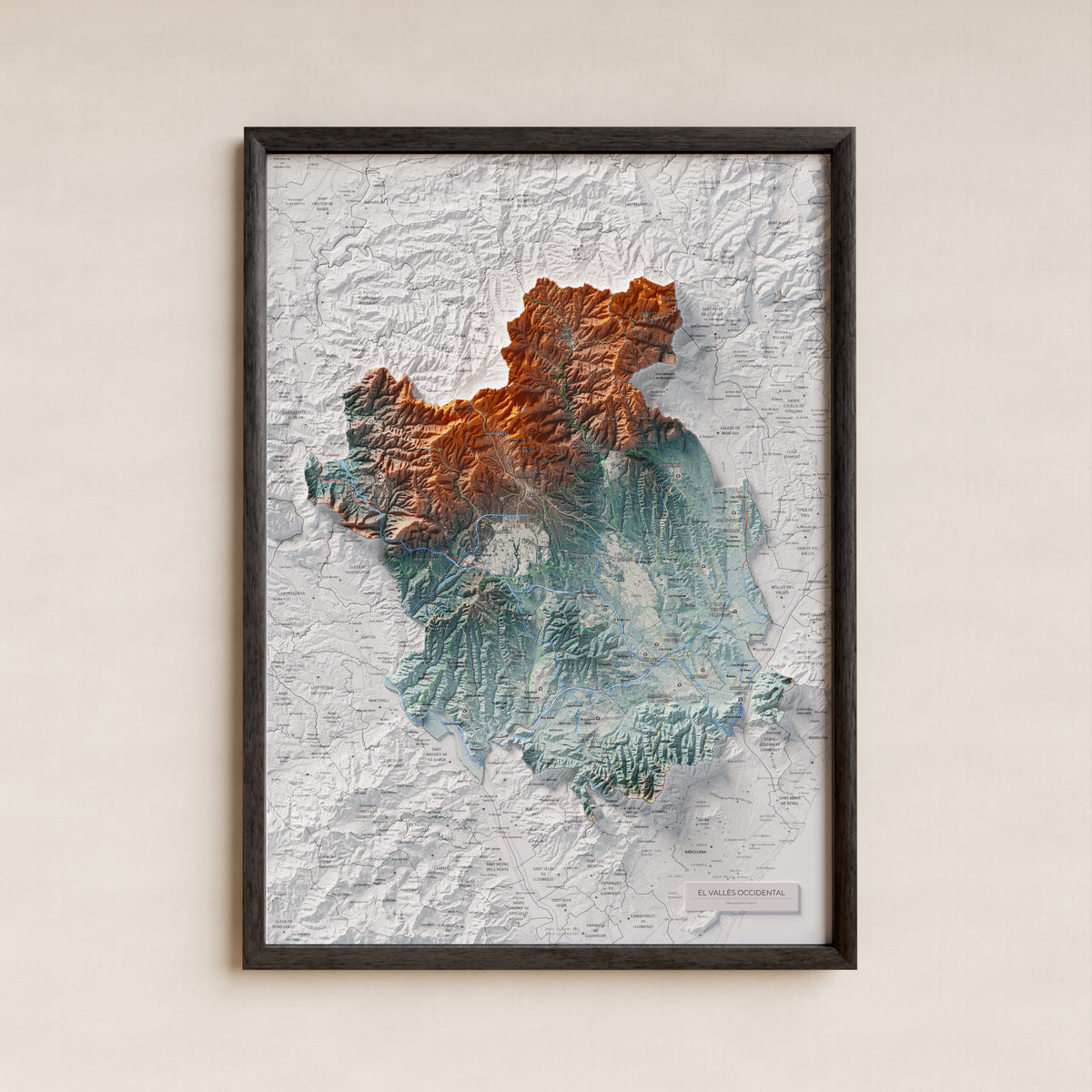 Mapa de relieve del Vallès Occidental, con el territorio en color y el entorno en blanco. Presentación con marco. 50 × 70 cm. Estilo Azul y naranja.
